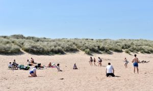 People enjoying the sunny weather on Newburgh Beach,