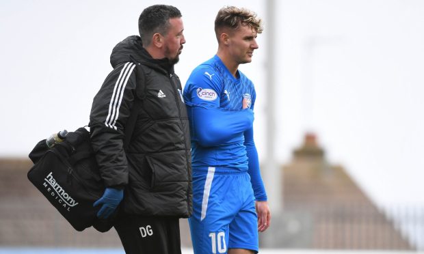 Peterhead's Kieran Shanks leave the Balmoor pitch against Queen's Park with a suspected broken collarbone. Image: Duncan Brown.