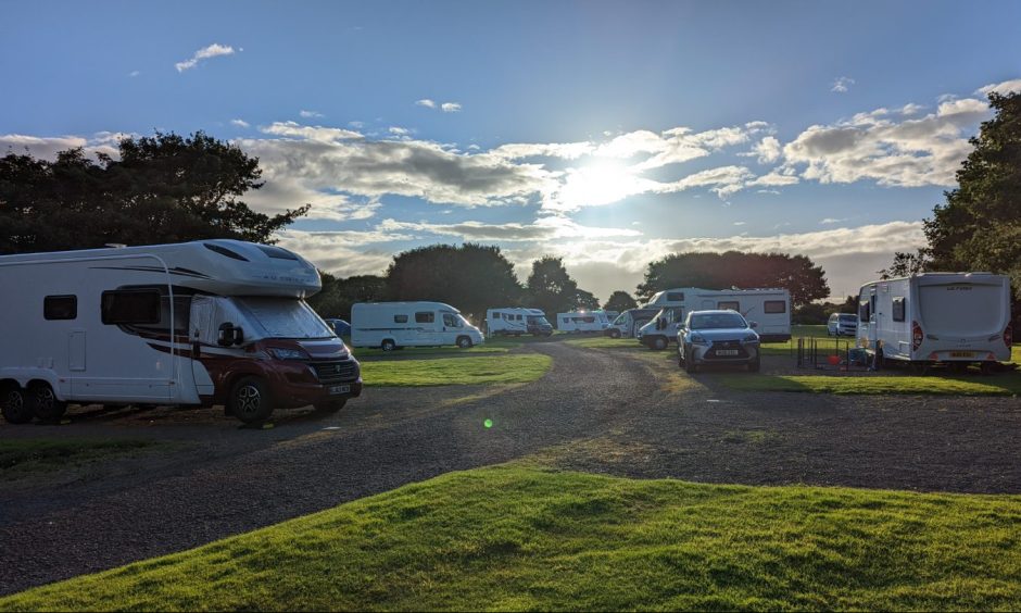 Motorhomes and caravans on a campsite.