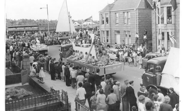1966: Peterhead Scottish Week carnival procession is headed by the prize-winning organisations - Sea Cadets, Young Unionists and Caledonian Amateur Swimming Club. Image: DC Thomson