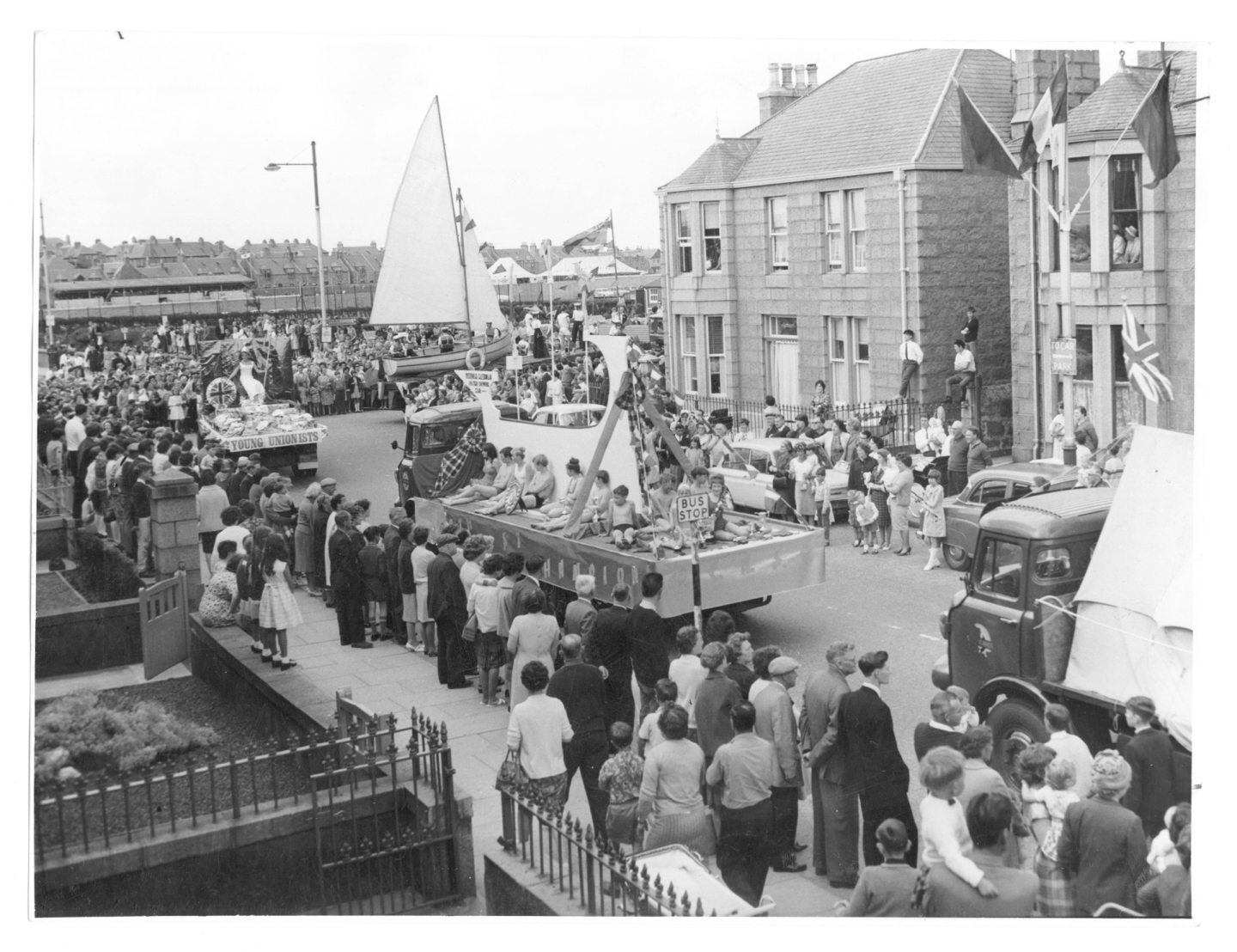 The Peterhead Scottish Week carnival procession with crowds of people in attendence