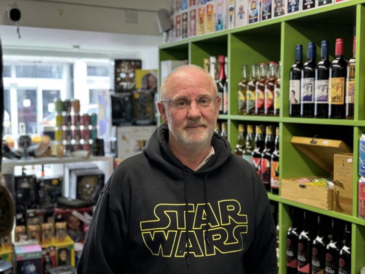 Robert macleod pictured in his shop poster world on dingwall high street