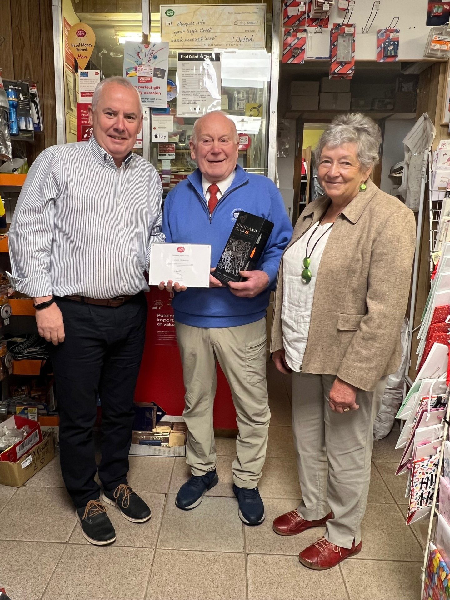 Marjorie and Alisdair Mackenzie with Post Office Regional Manager, Kenny Lamont pictured inside Rogart Post Office.