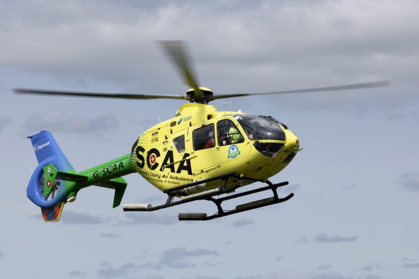 Yellow helicopter with green tail belonging to SCAA.