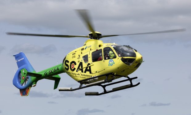 Yellow helicopter with green tail belonging to SCAA.