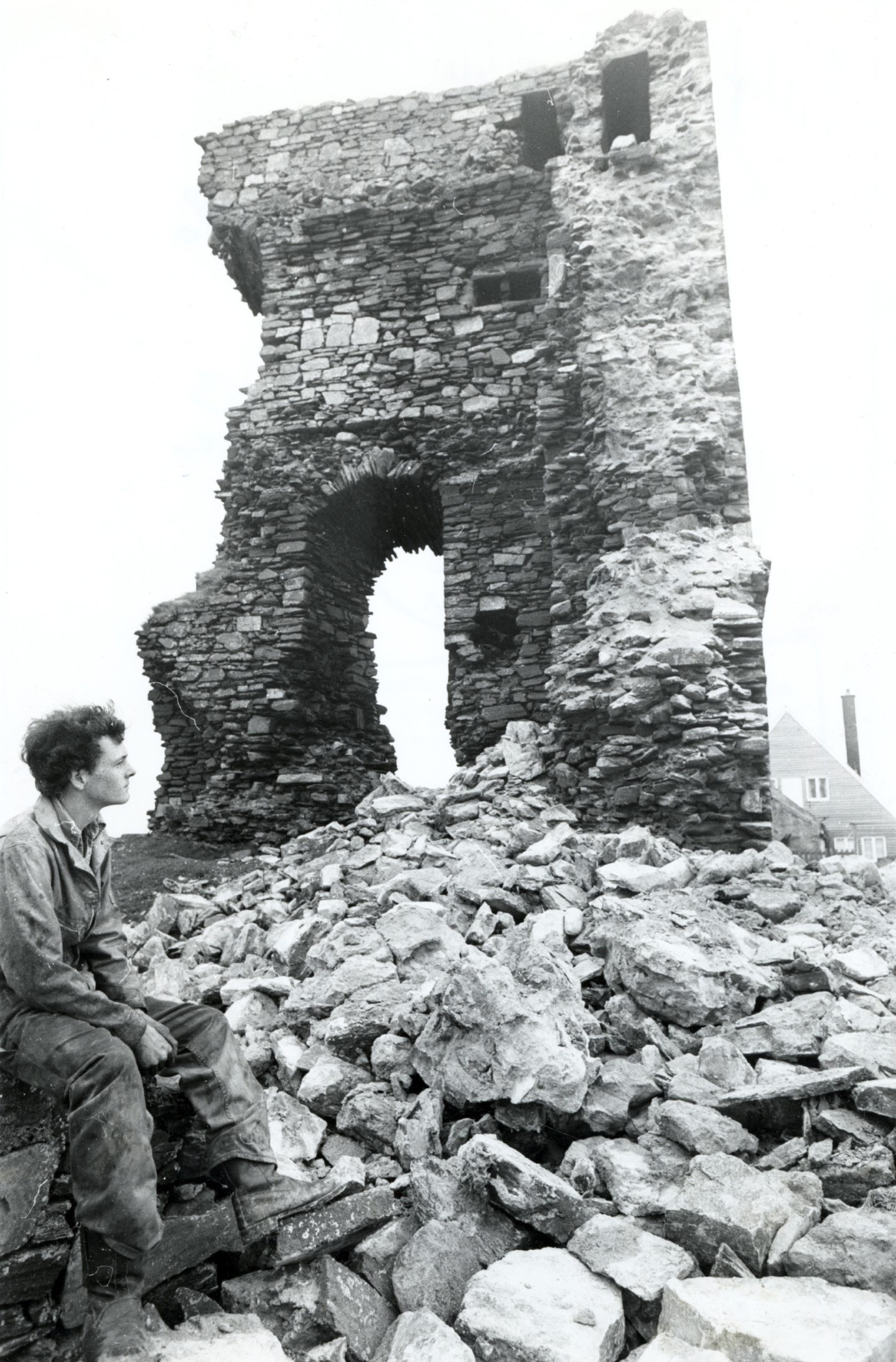 An image from May 1979, captioned: "Looking at the part of Slains Castle which collapsed yesterday is Kenny Bryce, son of the couple who live opposite the castle in Old Slains House." Image: AJL.