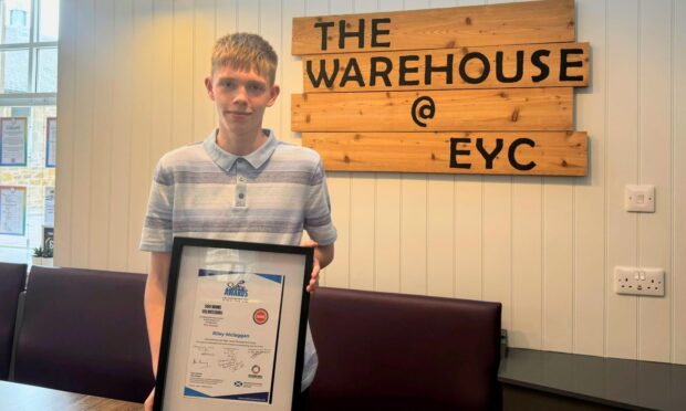 Riley standing with his Saltire award