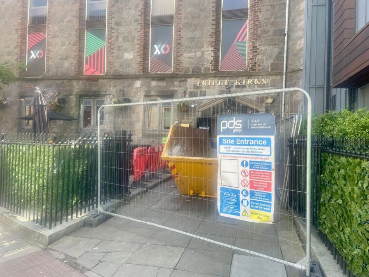 Skip and fence outside Triple Kirks 