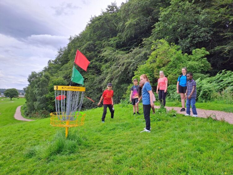 kids playing at the Inverness disc golf course