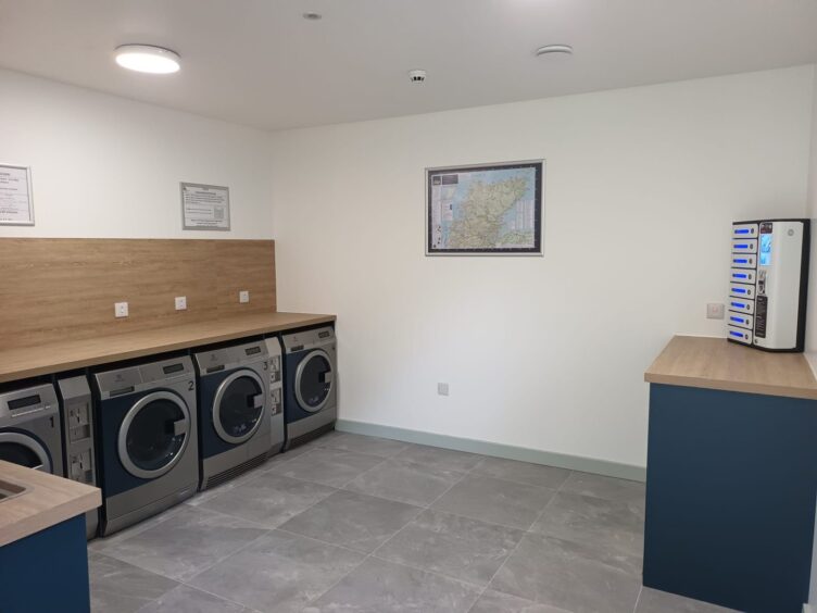 Laundry room with wooden work tops and washing machines.