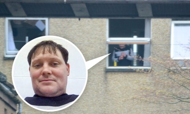 Lee Dyce stands at the window of his Inverness flat and shouts threats at police.