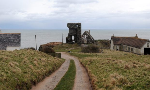 Old Slains Castle sits at the end of a path with the sea visible in the distance