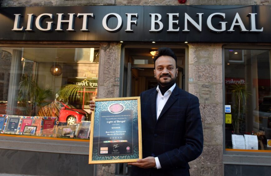 Noor Ahmed with his award at the Light of Bengal, Rose Street, Aberdeen.