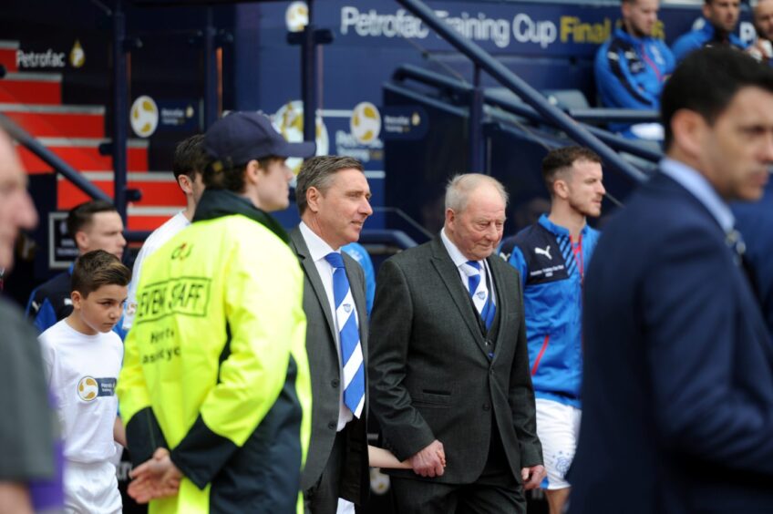 Peterhead's Norman "Bomber" Crighton leading the team out at the start of the game with manager Jim McInally. 