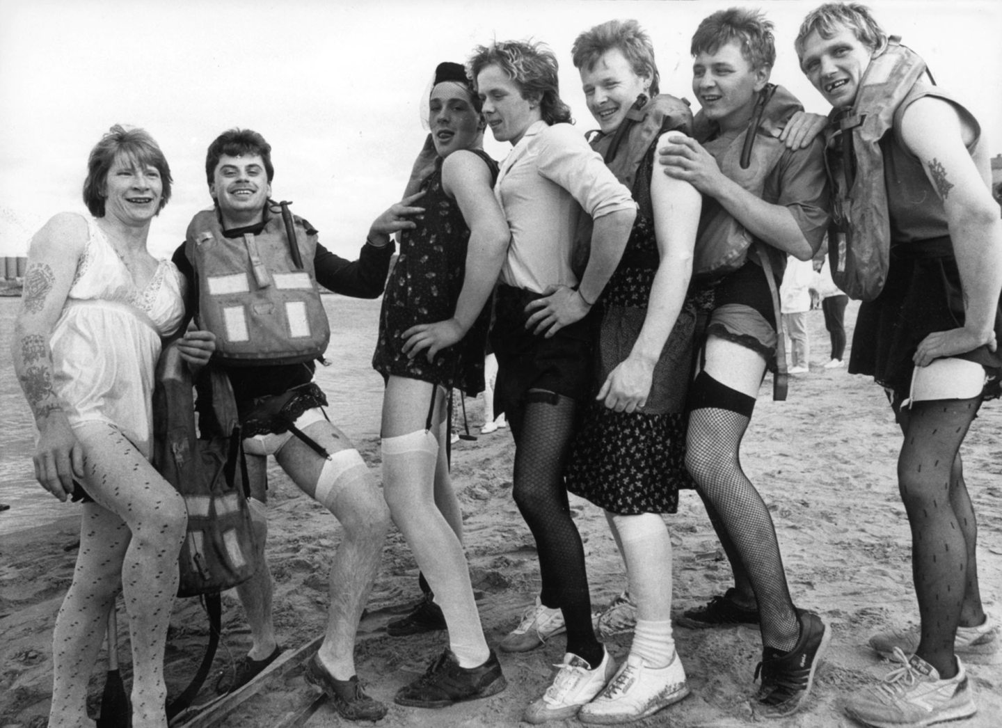 A team entering the raft race, each of the men are posing in stockings