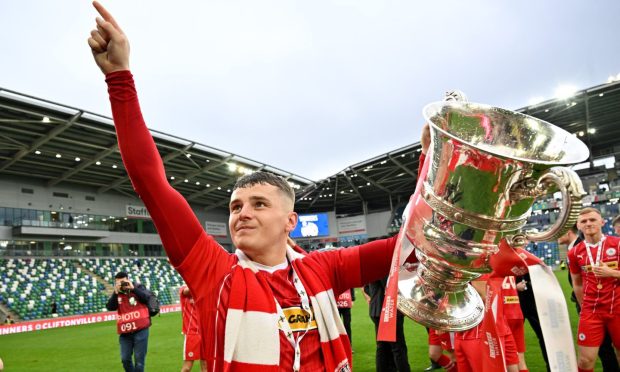 Cliftonville's Ronan Hale celebrates winning with the Irish Cup in May. Image: Shutterstock.