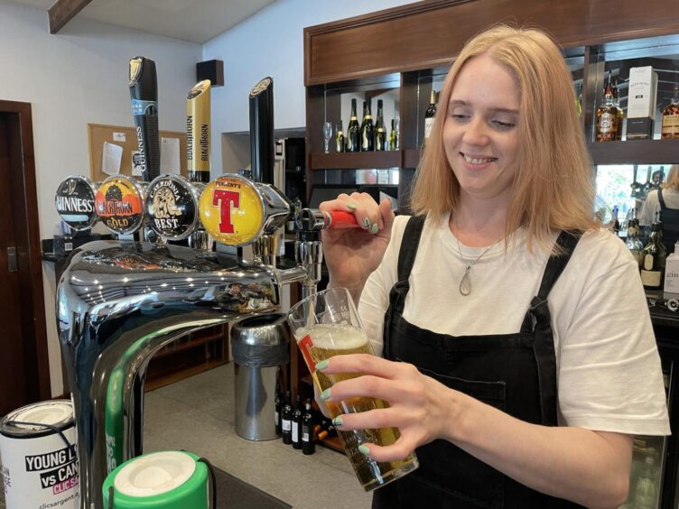 Lauren Stewart behind the bar of the Lochnell Arms Hotel.