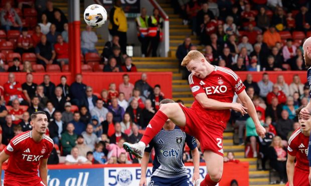 Aberdeen defender Gavin Molloy heads at goal during the Premier Sports Scottish League Cup match against Queen's Park. Image: Shutterstock.