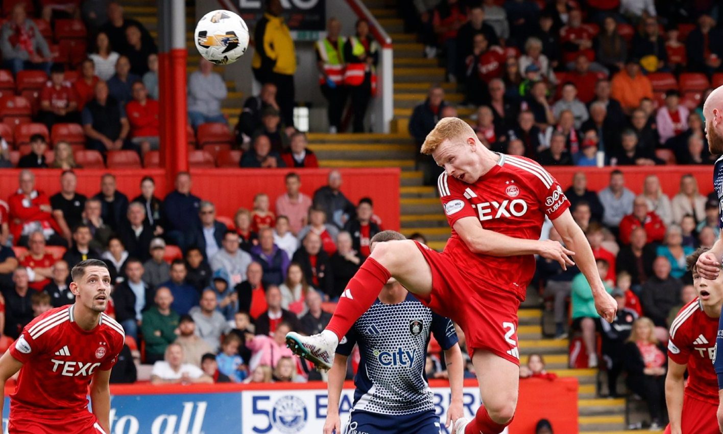 Aberdeen defender Gavin Molloy heads at goal during the Premier Sports Scottish League Cup match against Queen's Park. Image: Shutterstock.