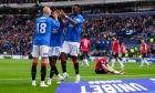 Rabbi Matondo of Rangers celebrates with team mates Vaclav Cerny and Mohamed Diomande after scoring his second goal of the game to give Rangers a 5-0 lead against Ross County. Image: Shutterstock.