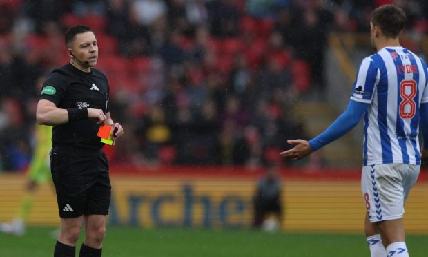 Referee Matthew MacDermid shows a red card to Brad Lyons of Kilmarnock against Aberdeen. Image: Shutterstock.