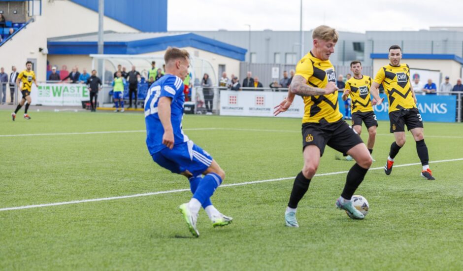 Cove's Adam Emslie scores against Dumbarton. Image: Dave Cowe.