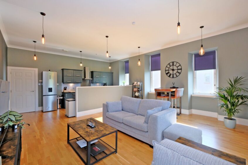 Living area at 25 Marshall Mackenzie Road, with stylish pendant lights.