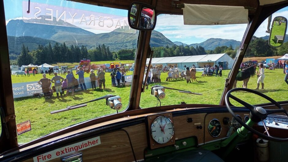 The view from inside a vintage vehicle at a past event.