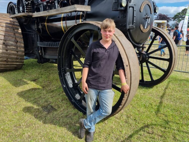 Findlay Lawson leans on one of the giant Erebus wheels. He is a graduate-apprentice with Cameron Anderson of Subsea Tooling, Old Meldrum.