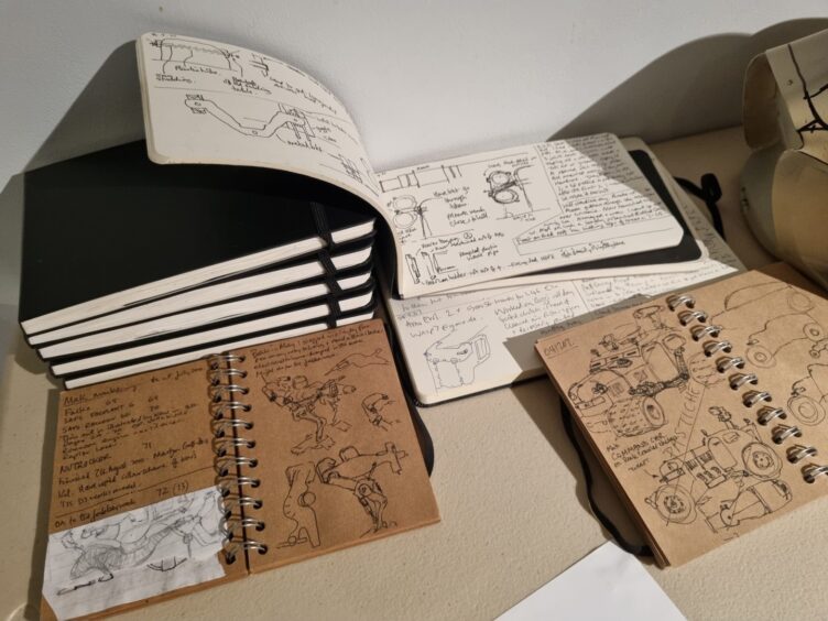 A collection of Mark's creative notebooks with drawings for his models.