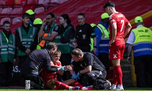Aberdeen's Leighton Clarkson goes down injured during the Premier Sports Cup group stage match against Dumbarton. Image: SNS.