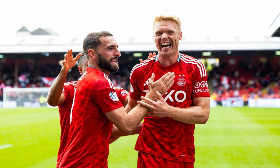 Aberdeen's Graeme Shinnie and Sivert Heltne Nilsen celebrate as Topi Keskinen scores to make it 1-0 against Queen's Park. Image: SNS