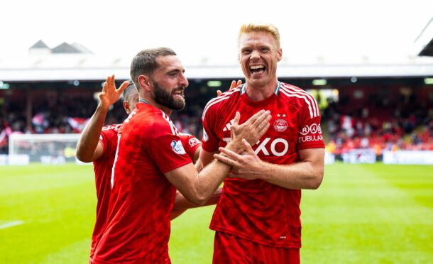 Aberdeen's Graeme Shinnie and Sivert Heltne Nilsen celebrate as Topi Keskinen scores to make it 1-0 during a Premier Sports Cup last sixteen match between Aberdeen and Queen's Park at Pittodrie Stadium, on August 17, 2024, in Aberdeen, Scotland.  (Photo by Ross Parker / SNS Group)