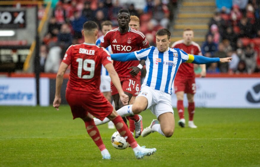 Kilmarnock's Brad Lyons puts in a challenge on Aberdeen's Ester Sokler. Image: SNS.