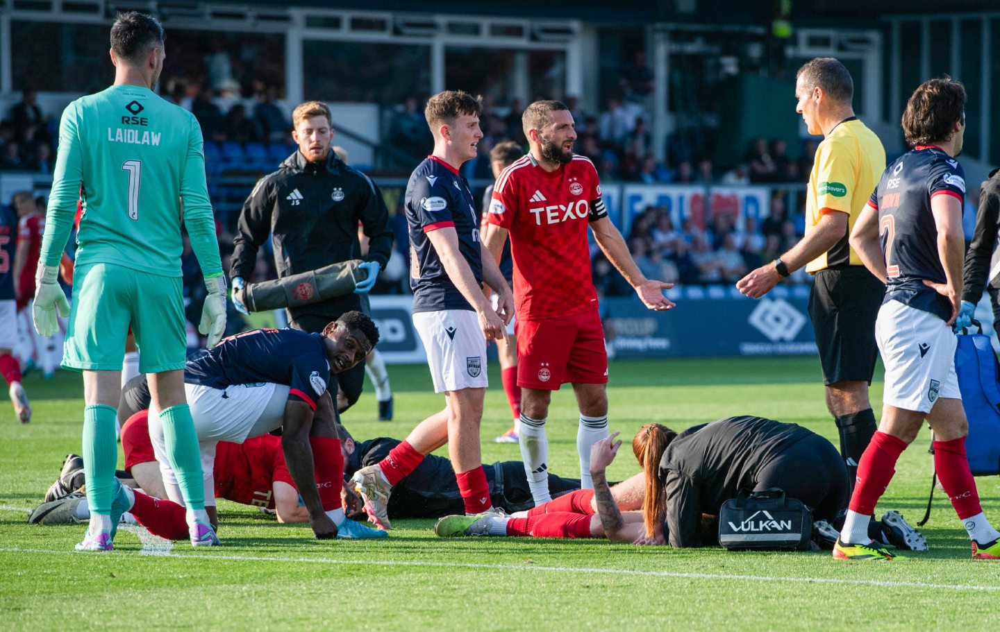 Aberdeen's Jamie McGrath and Ross County's Kacper Lopata go down after a head collision. Image: SNS