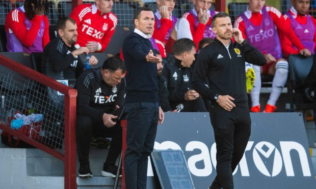 Dundee United manager Tam Courts held up a 'show racism the red card' T-shirt at full-time.