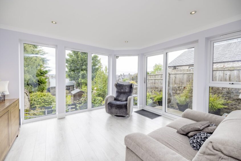 Lounge room at 27 Hamilton Place, with floor-to-ceiling windows.