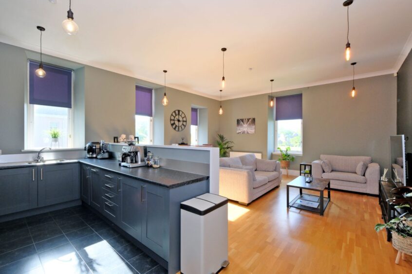 Bright, open-plan lounge, dining room and kitchen area at the flat for sale in Kingseat, Aberdeen.