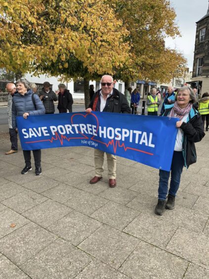 Campaigners hold a "Save Portree Hospital" banner.