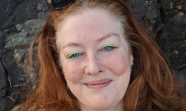 Heather air with ginger hear and a green dress with black design.