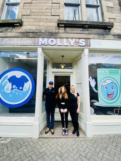 Molly's Laundrette staff standing outside the building