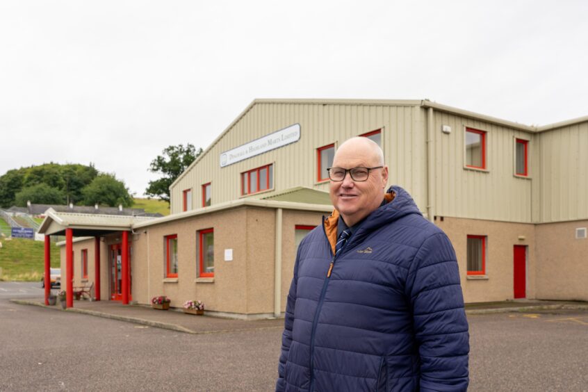 Andrew in front of Dingwall and Highland Marts Ltd on the outskirts of the town.