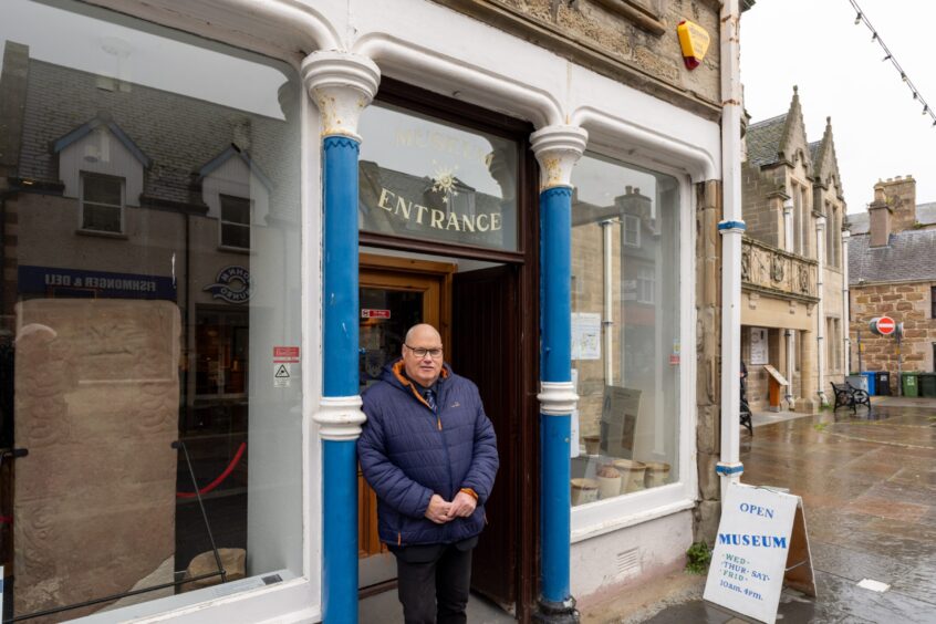 Andrew on the High Street, standing outside Dingwall's museum.