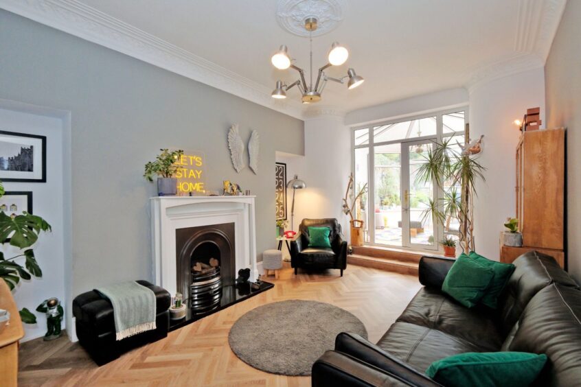 Lounge area at 25 Belvidere Street, featuring herringbone flooring and a fireplace.