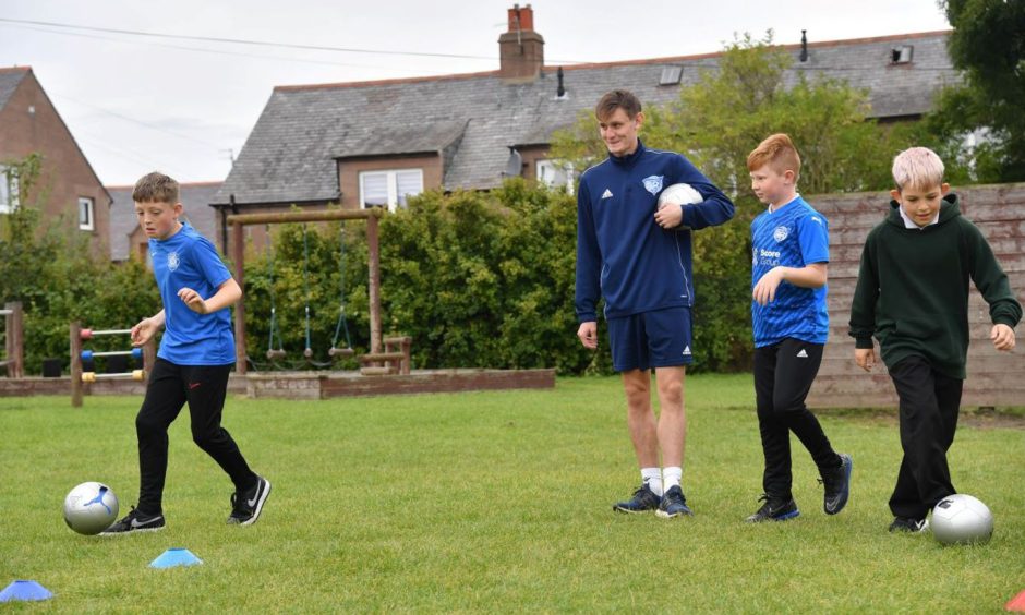 Danny with some Buchanhaven Primary School Pupils during one of his sports sessions. Image: Peterhead FC Community Foundation