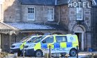 Police vans sitting outside the Huntly Arms Hotel in Aboyne last January