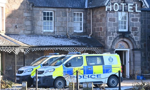 Police vans sitting outside the Huntly Arms Hotel in Aboyne last January