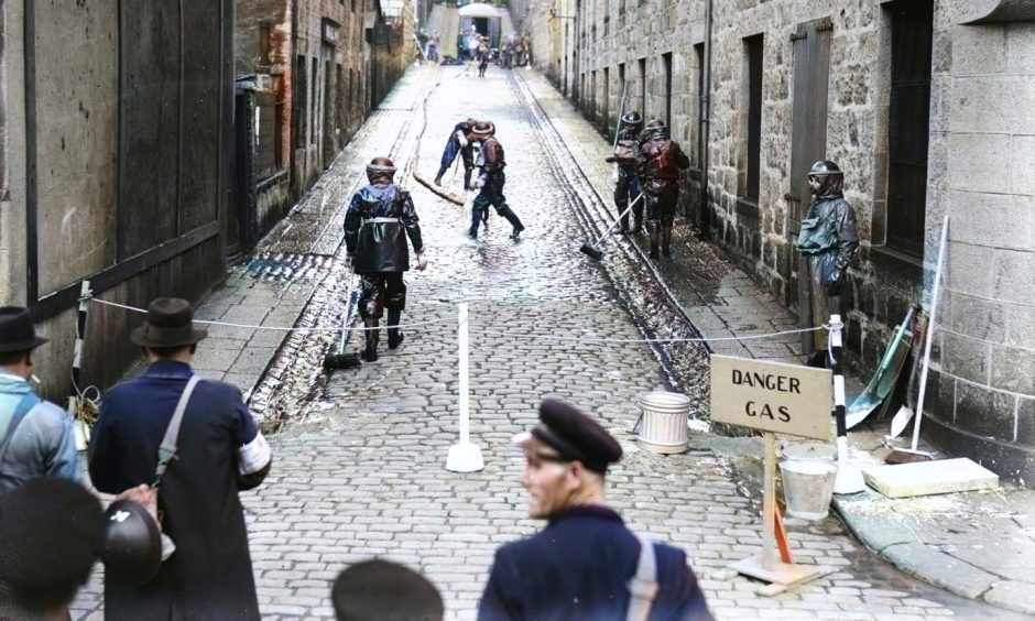 A decontamination and rescue squad practising at Innes Street on August 29 1940 seen in colour for the first time, thanks to AI technology. Image: DC Thomson