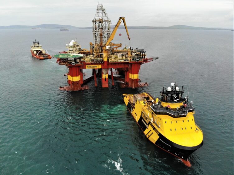 Oil rig and boat in North Sea.