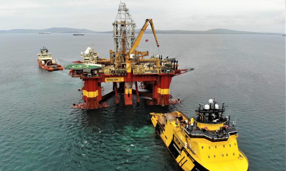 Oil rig and boat in North Sea.